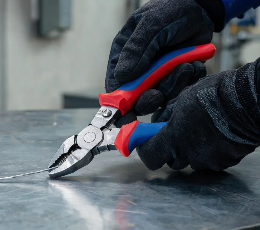 Professional using Knipex pliers on a workbench